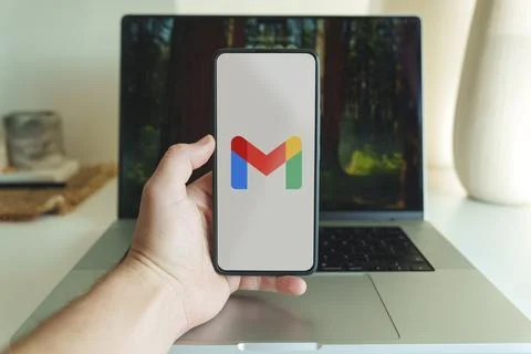 Gmail email application logo in front of laptop. High quality photo Stock Photos