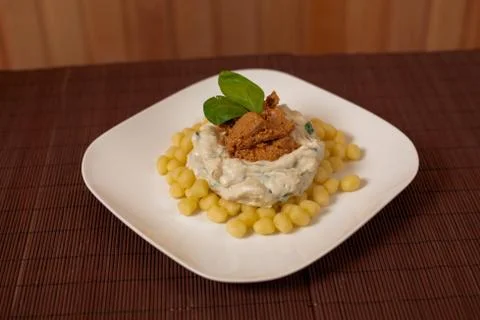 Gnocchi and spinach. Stock Photos