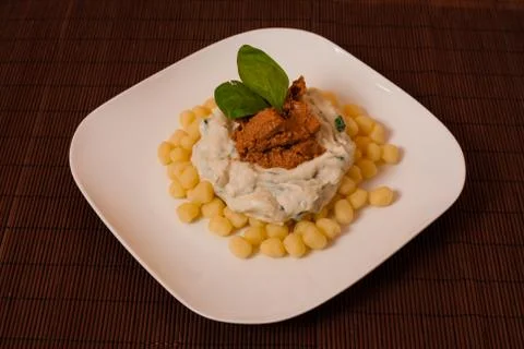 Gnocchi and spinach. Stock Photos