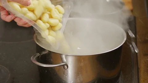 Gnocchi being added into a pot with hot water Video stock 84147614
