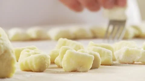 Gnocchi being rolled over a fork Stock Footage 24643344