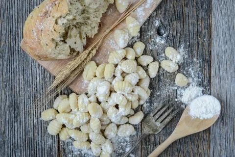 Gnocchi on cutting board and rustic wood background Stock Photos