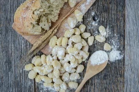 Gnocchi on cutting board and rustic wood background Stock Photos