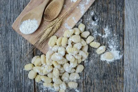 Gnocchi on cutting board and rustic wood background Stock Photos