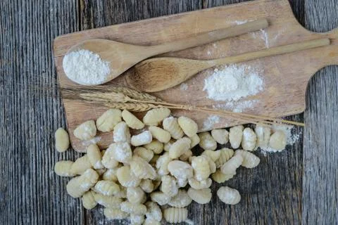 Gnocchi on cutting board and rustic wood background Stock Photos