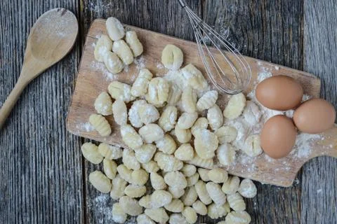 Gnocchi on cutting board and rustic wood background Stock Photos