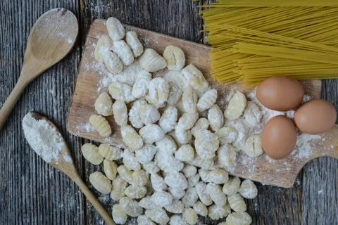 Gnocchi on cutting board and rustic wood background Stock Photos