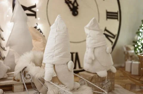 Gnomes Plush Handmade on Background of Large Clock. Christmas Interior. Stock Photos
