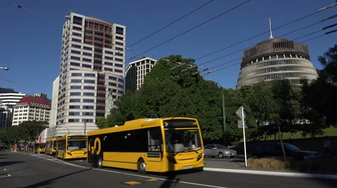 Go electric buses, passes beehive, Wellington, New Zealand Stock Footage 48239364