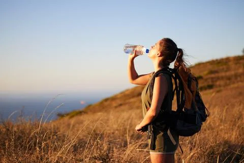 Go explore but make sure you have enough water. a young woman drinking water Foto stock