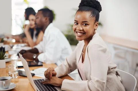 Go-getters know how to make it happen. Portrait of a young businesswoman using a Stock Photos
