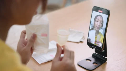 Go green zero waste reusable period cup live stream selfie talk on phone 스톡 동영상 281654350
