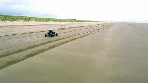 Go Kart Drives Up Empty Beach Aerial Drone Footage Stock Footage 196983979