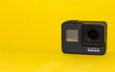Go pro camera on a yellow background. Isolated object Stock Photos