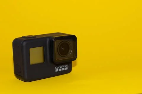 Go pro camera on a yellow background. Isolated object Stock Photos