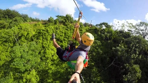 Go Pro shot of zip line in Hawaii while screaming. Fast and high zip line Stock Footage 99376592