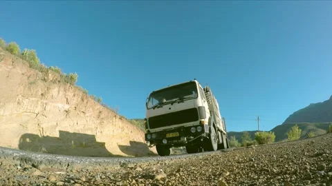 A Go Pro wide shot on a ground level captures vehicles driving on a Stock Footage 241303068