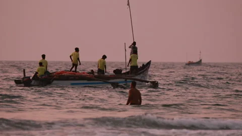 Goa, India - February 10, 2020: Fishermen In Boat Pulling Fishing Net At Sunset Stock Footage 133188233