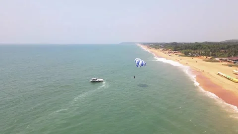 Goa Sinquerim Beach drone bird's eye view paragliding in goa  zoom outshot Stock-Footage 153011964