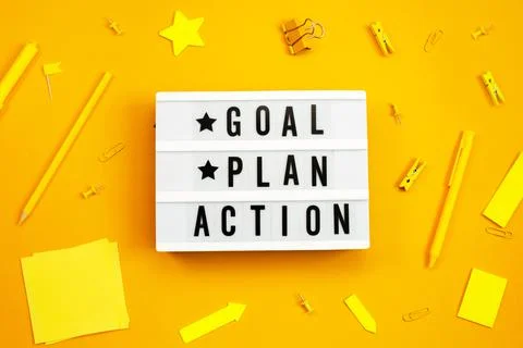 Goal, Plan, Action text on light box on yellow background. Foto stock