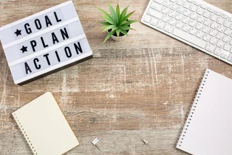 Goal, Plan, Action text on light box and Notebook Stock Photos