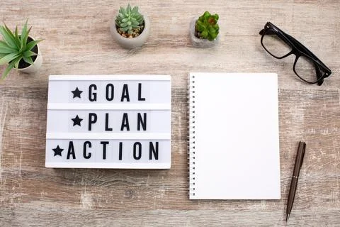 Goal, Plan, Action text on light box and Notebook Stock Photos