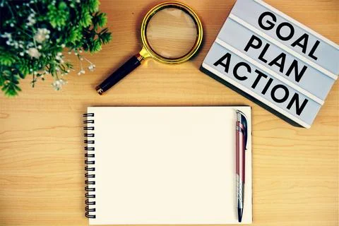 Goal, Plan, Action text in lightbox with magnifying glass and notepad flat .. Stock Photos