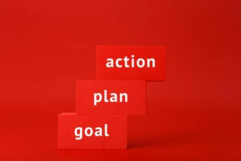 Goal, plan, action written on red rectangles as a ladder against red background Stock Photos
