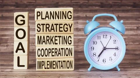 Goal plan with keywords and elements on wooden blocks and wooden background w Stock Photos