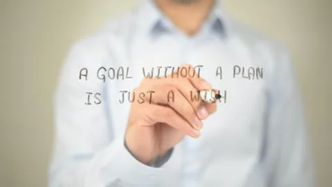 A Goal Without a Plan is Just a Wish, Man writing on transparent screen Stock Photos