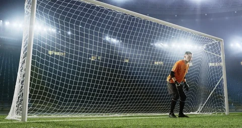 Goalkeeper fails to save from a goal on the empty soccer stadium Stock Footage 126525488