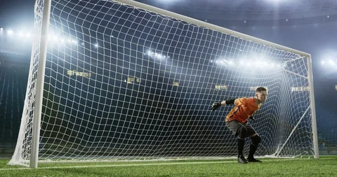 Goalkeeper fails to save from a goal on the empty soccer stadium Stock Footage 126525765