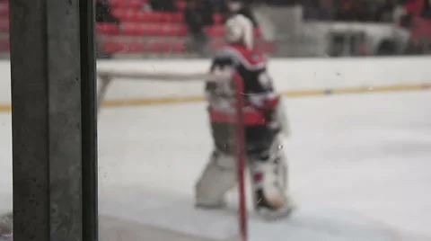 Goalkeeper ready to face rival attack during ice hockey match, defending the net Video stock 63090872