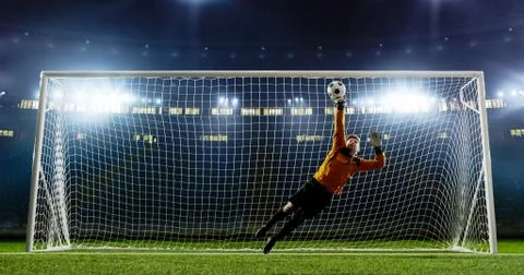 Goalkeeper is trying to save from a goal on an empty soccer stad Fotos Stock