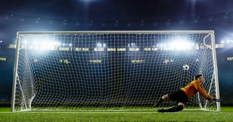 Goalkeeper is trying to save from a goal on an empty soccer stad Fotos Stock