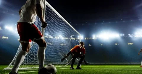 Goalkeeper is trying to save from a goal on an empty soccer stad Stock Photos
