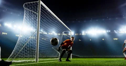 Goalkeeper is trying to save from a goal on an empty soccer stad Stock Photos