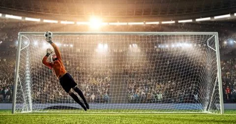 Goalkeeper is trying to save from a goal in a jump Stock Photos