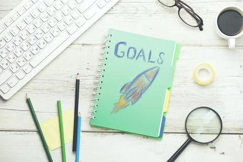 Goals text with racket on notepad and keyboard on table Stock Photos