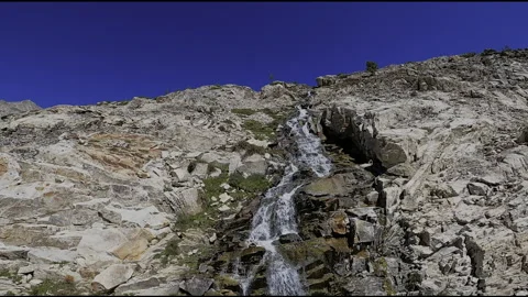 Goat Lake Falls FPV Dive: Dramatic Alpine Waterfall Descent - Pioneer Mountains Stock Footage 331898301