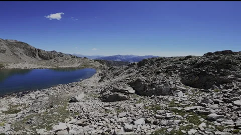 Goat Lake FPV Dive: High-Alpine Ridge to Crystal Clear Basin - Idaho Pioneer's Stock Footage 331897017