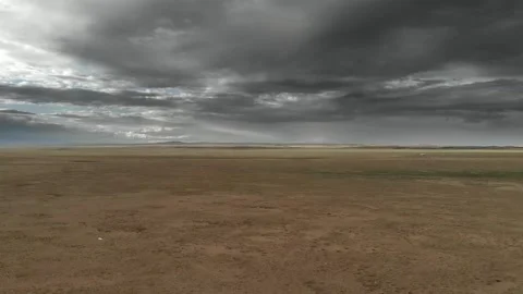 Gobi Desert landscape in Mongolia spans barren plains beneath dark storm clouds Stock Footage 339795422