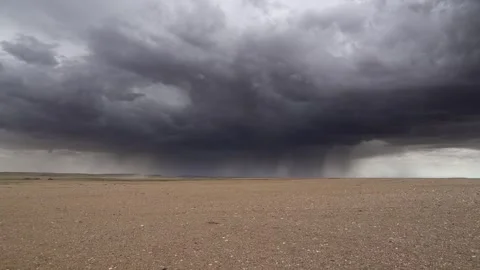 Gobi Desert in Mongolia lies beneath storm clouds - Dry Climate and Barren Land Stock Footage 339795084