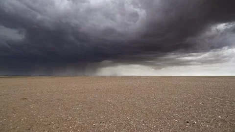 Gobi Desert in Mongolia lies beneath storm clouds - Arid Terrain and Dry Plains Stock Footage 339795111