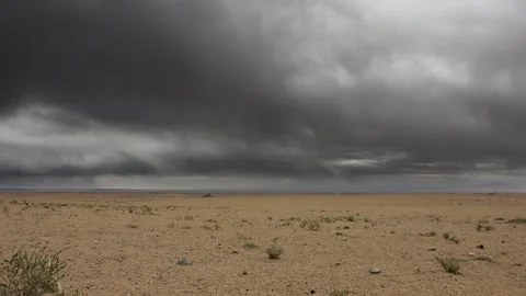 Gobi Desert in Mongolia lies beneath storm clouds - Dry Climate and Cloud Layer Stock Footage 339795342