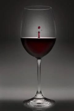 Goblet of red wine with drop Stock Photos