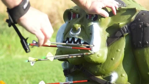 Goblin archery target pulling arrows out live action role play Stock Footage 171996598