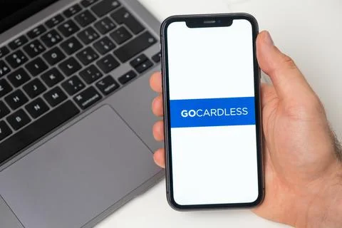 Gocardless crypto wallet logo on the screen of mobile phone and notebook on the Stock Photos