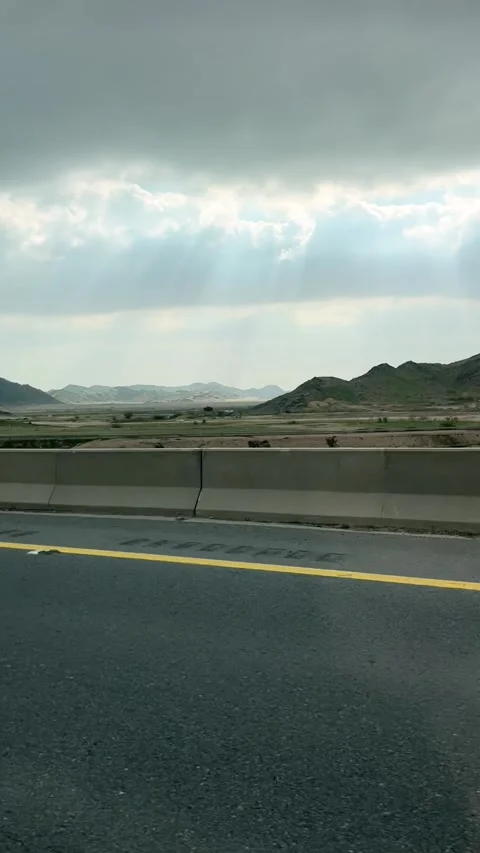 God rays illuminating the desert terrain along the Mecca to Medina highway Stock Footage 342773826