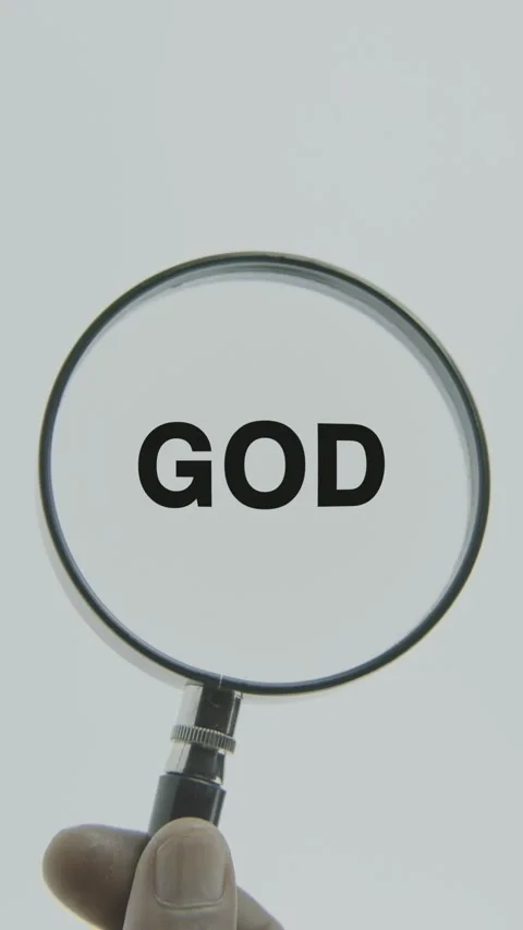 God text or word highlighted by a magnifying glass in a hand on a white Stock Footage 303450711